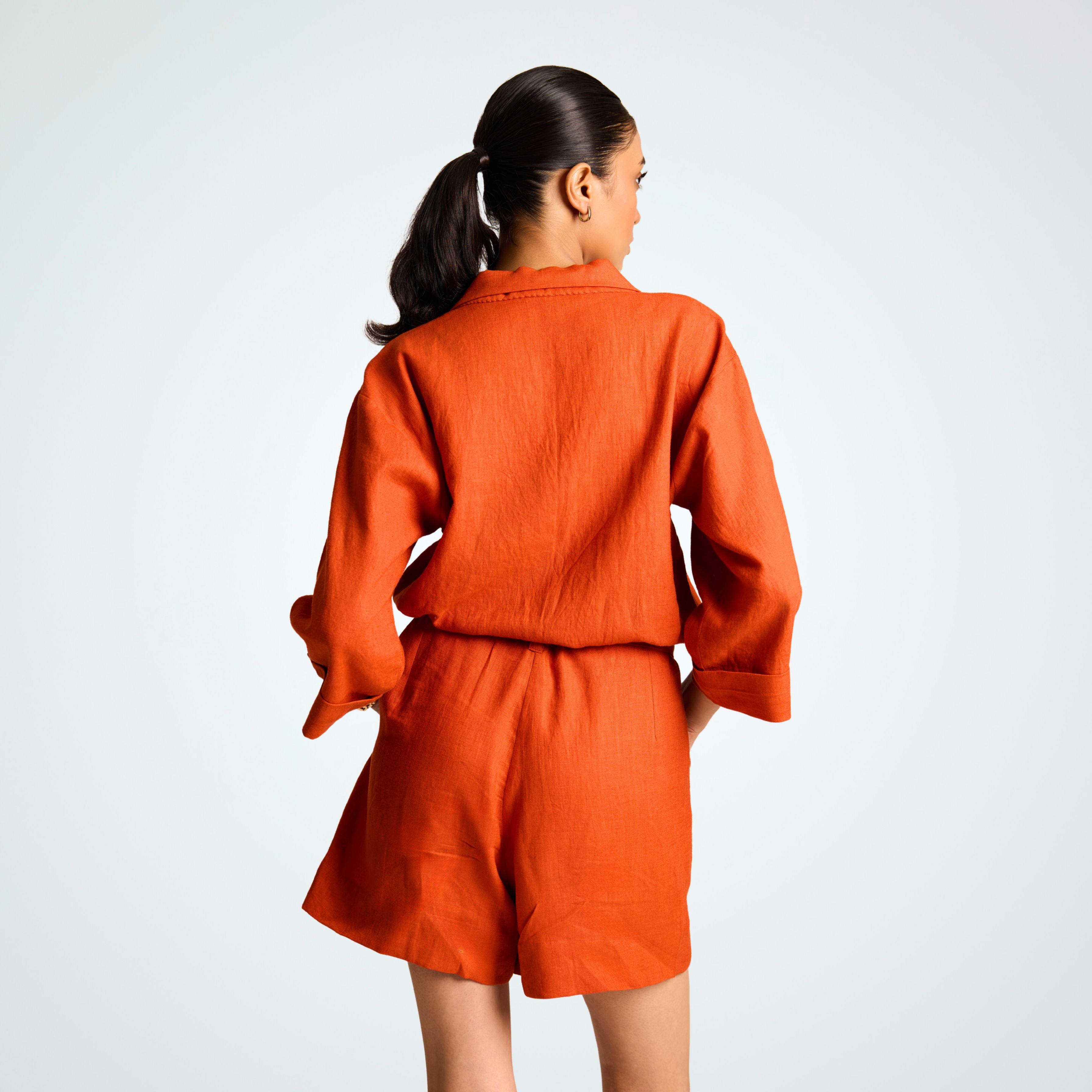 Relaxed orange rust linen playsuit with ¾ sleeves, roomy shorts, and a belt. Breathable comfort and effortless movement for any day | Selfish Clarity