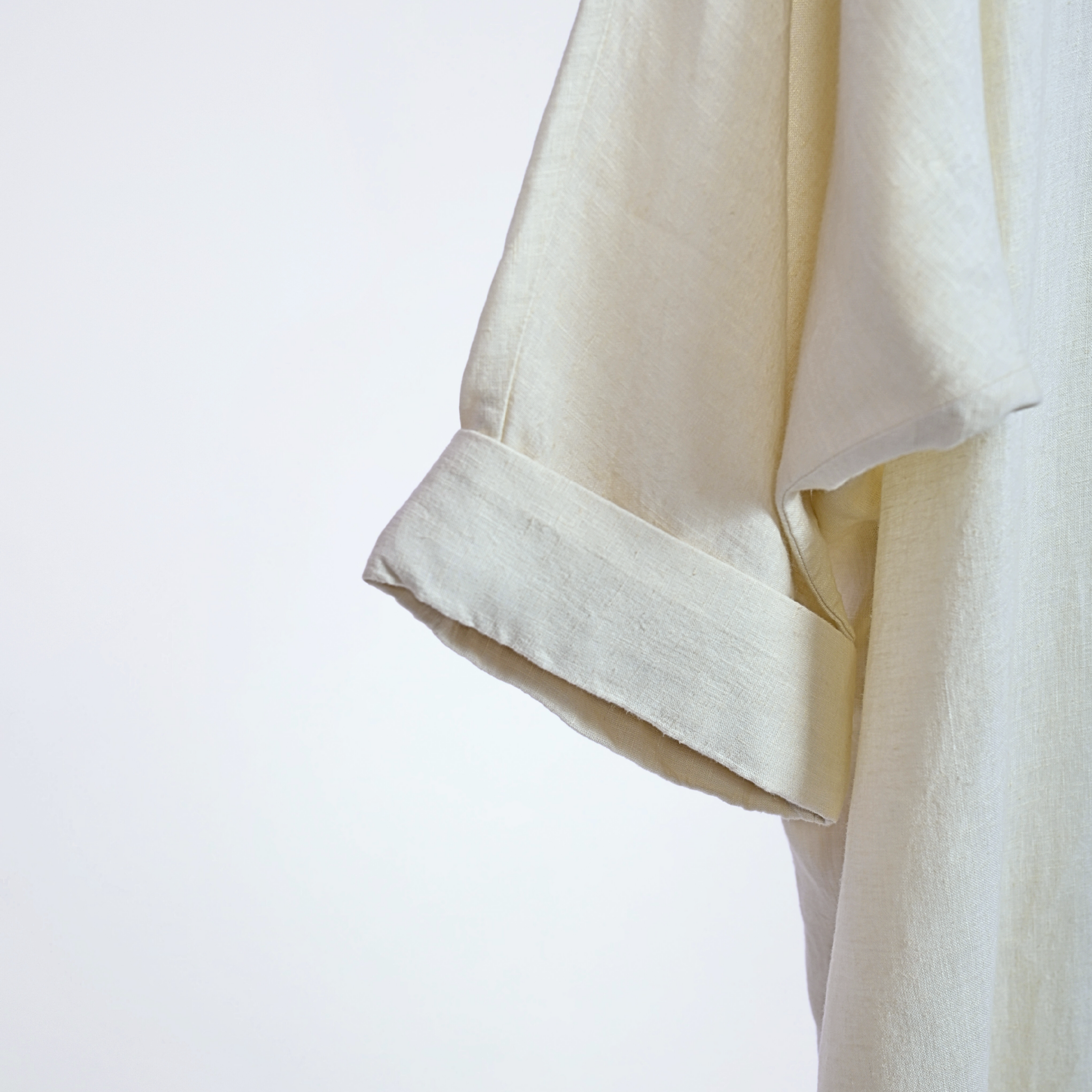 Pearl linen long shrug with a lapel collar and a button. Breathable, flowing, and versatile for no-effort layering | Selfish Clarity