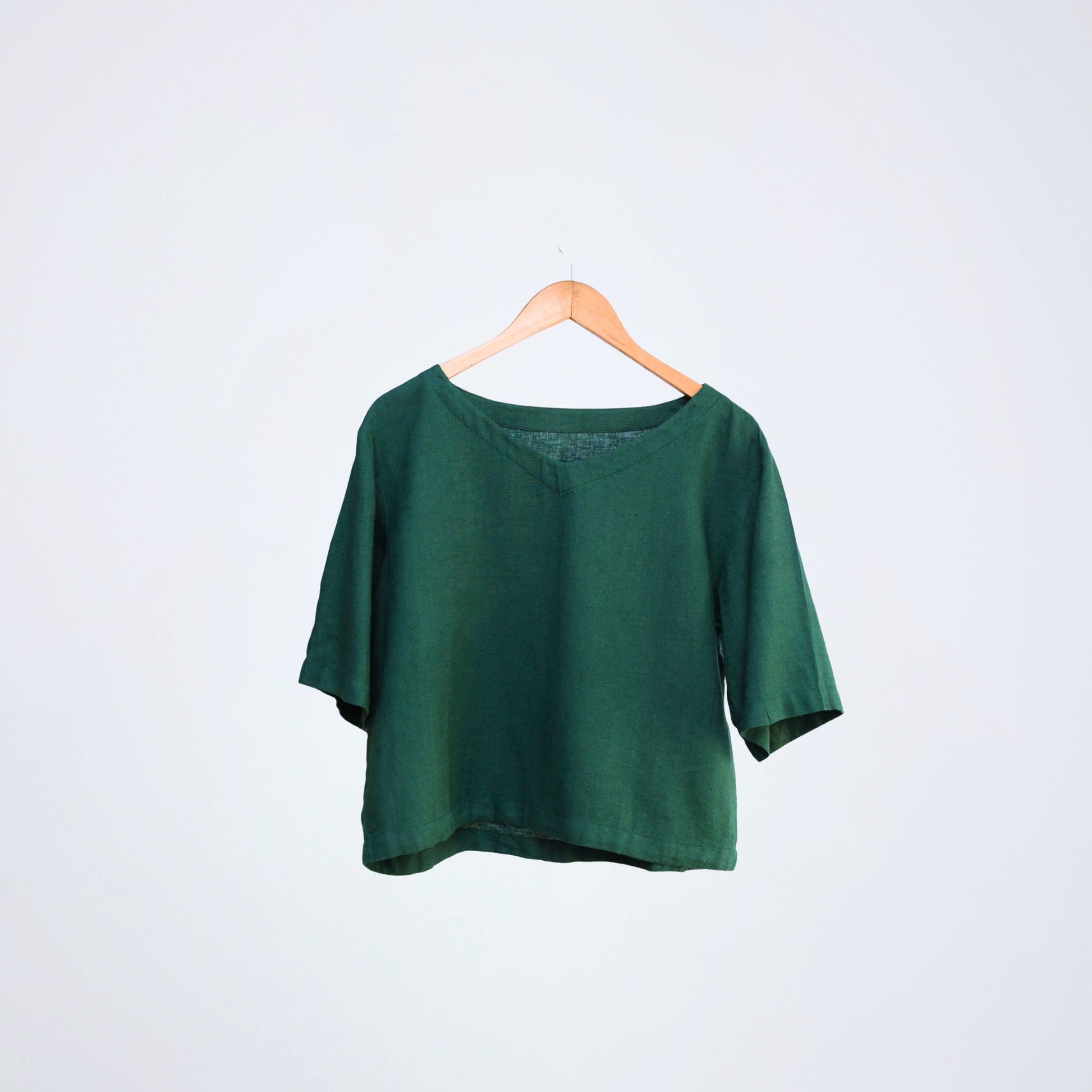 Breathable linen top with elbow-length sleeves. Relaxed fit for long days, in emerald tone - made for different settings