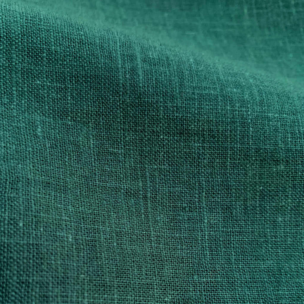 Close-up of textured emerald linen fabric