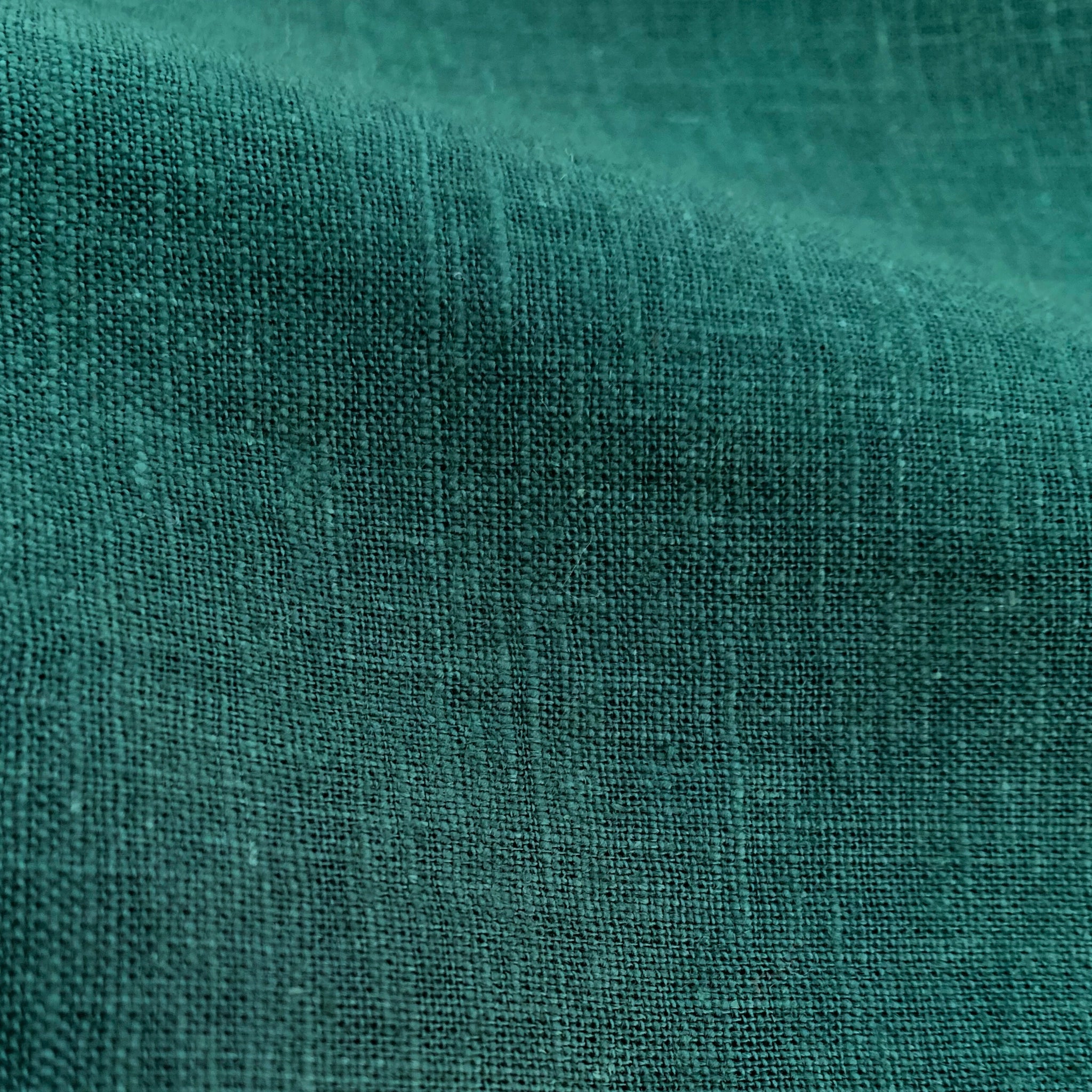 Close-up of emerald linen shorts fabric texture
