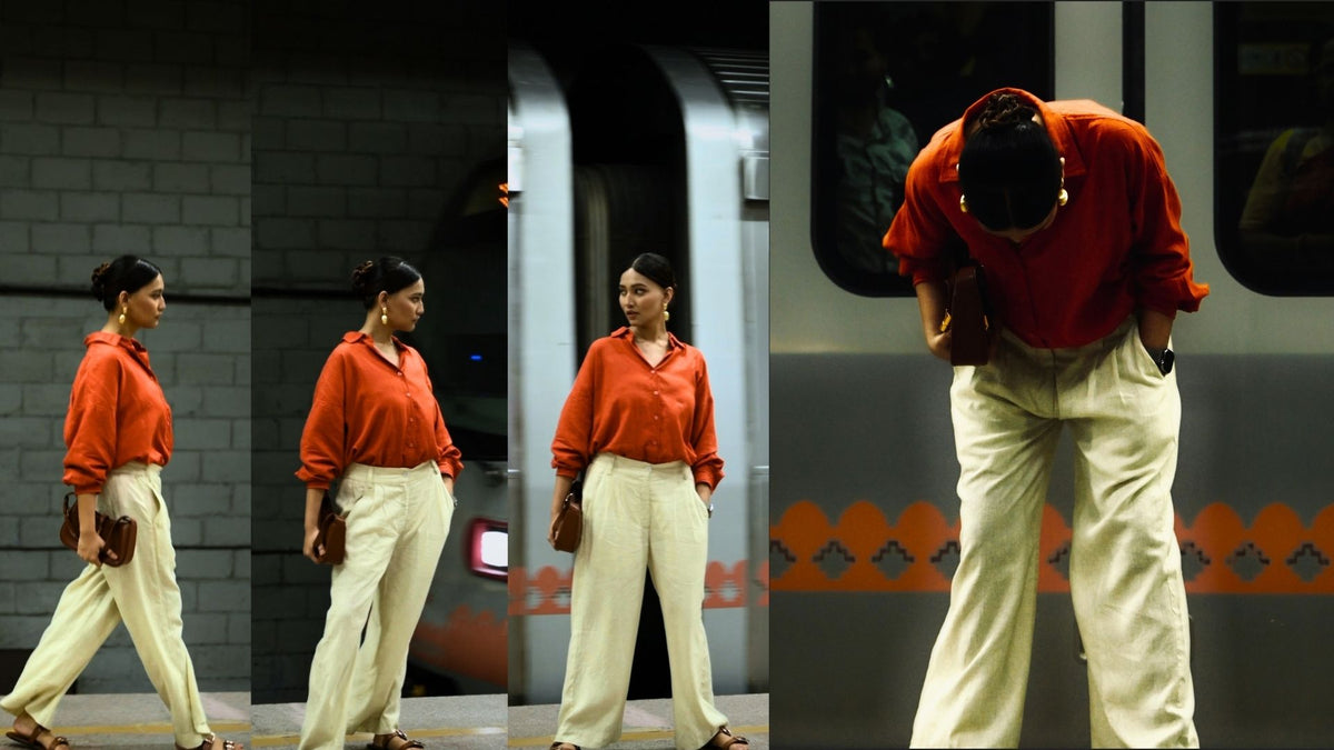 Modern girl in chic linen outfit in front of a running metro.