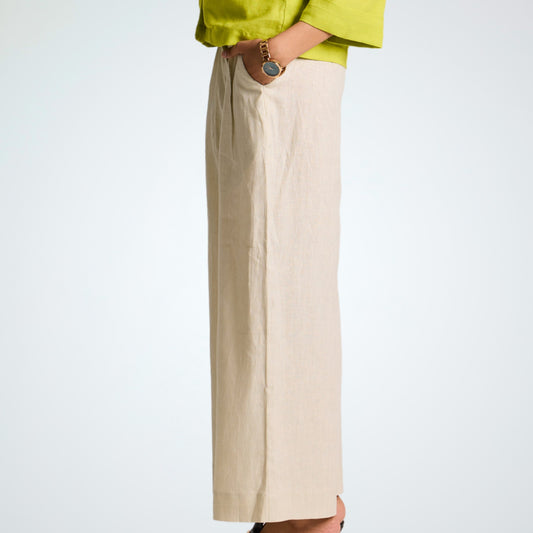 Pearl white linen pants with soft pleats and a stretch waist. Lightweight, breathable, and roomy for comfort and movement