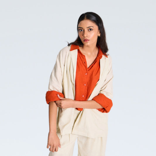 White linen shrug with lapel collar and a button. Breathable, relaxed, and lightweight – adapts easily for everyday wear
