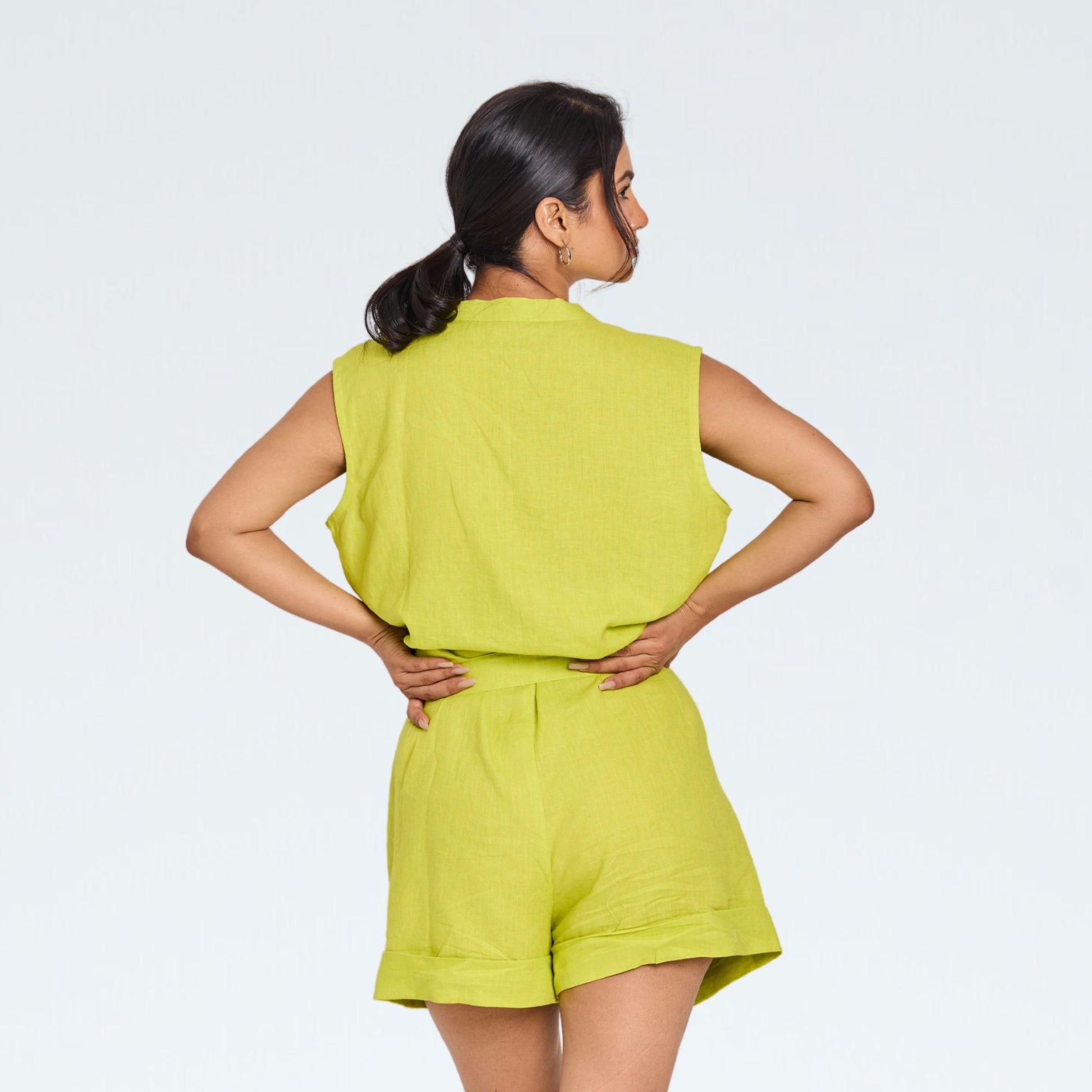Sleeveless green linen playsuit with comfy shorts. Breathable fabric, relaxed fit, and effortless all-day ease