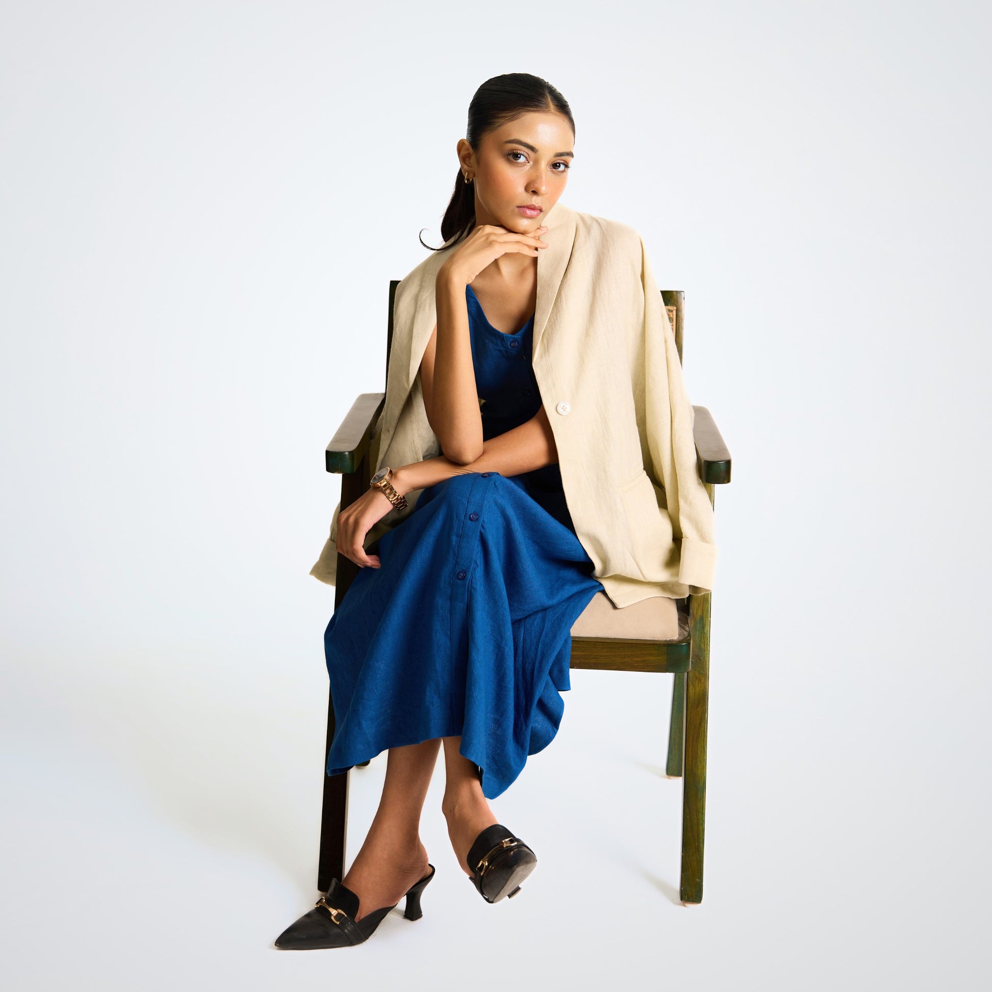 Sleeveless button-front linen midi dress with A-line fall. Breathable, airy, and effortlessly grounded for your days