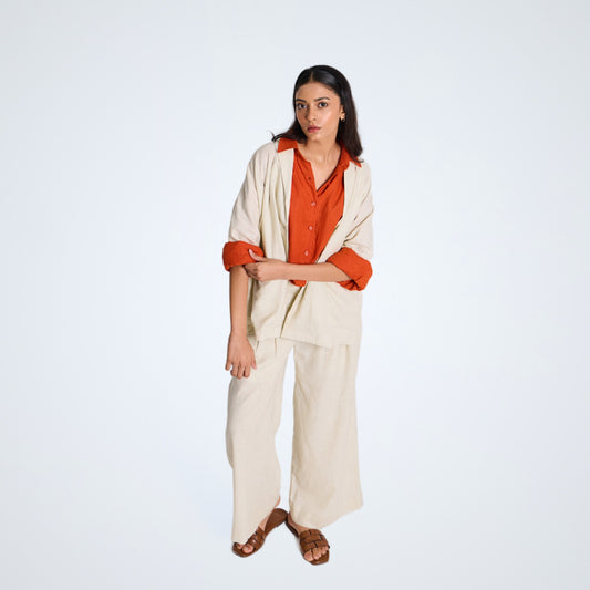 White linen shrug with lapel collar and a button. Breathable, relaxed, and lightweight – adapts easily for everyday wear