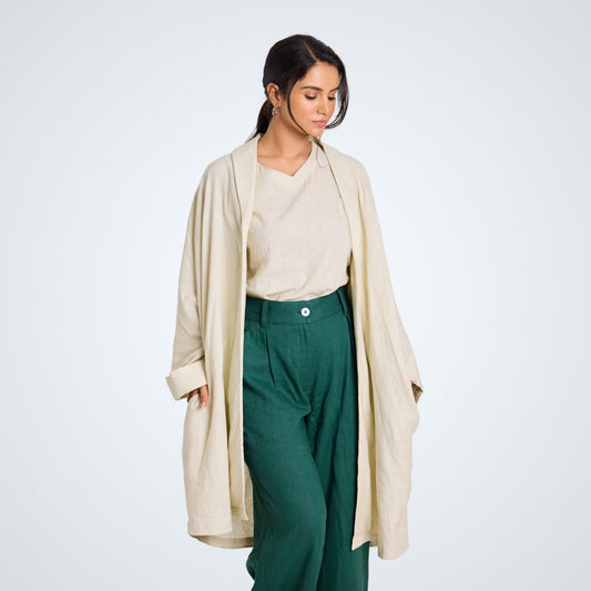 Long pearl white linen shrug with lapel collar and a button. Breathable, flowing, and versatile for no-effort layering