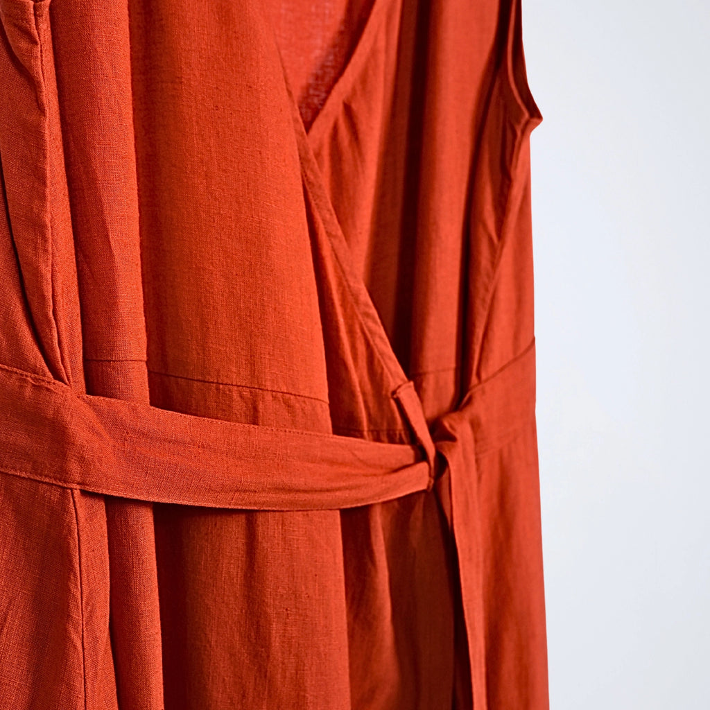 Sleeveless orange rust linen dress with pleated wrap fall. Breathable, relaxed, and fluid for moving forward with ease | Selfish Clarity